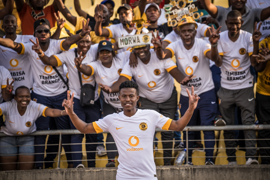 Happy Mashiane posing next to Kaizer Chiefs Supporters in the DStv Premiership at Royal Bafokeng in the mining town of Rustenburg